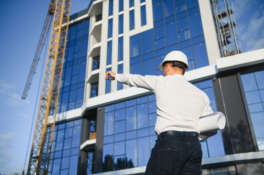Construction supervisor directing work on a modern building