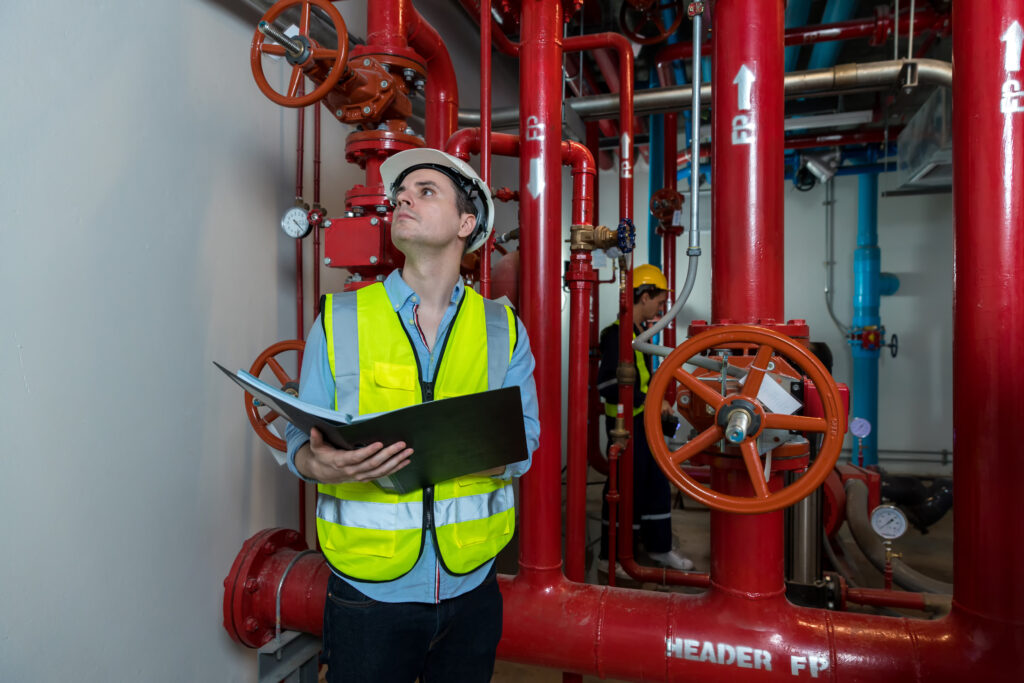 Engineer inspecting a sprinkler pipe system on site