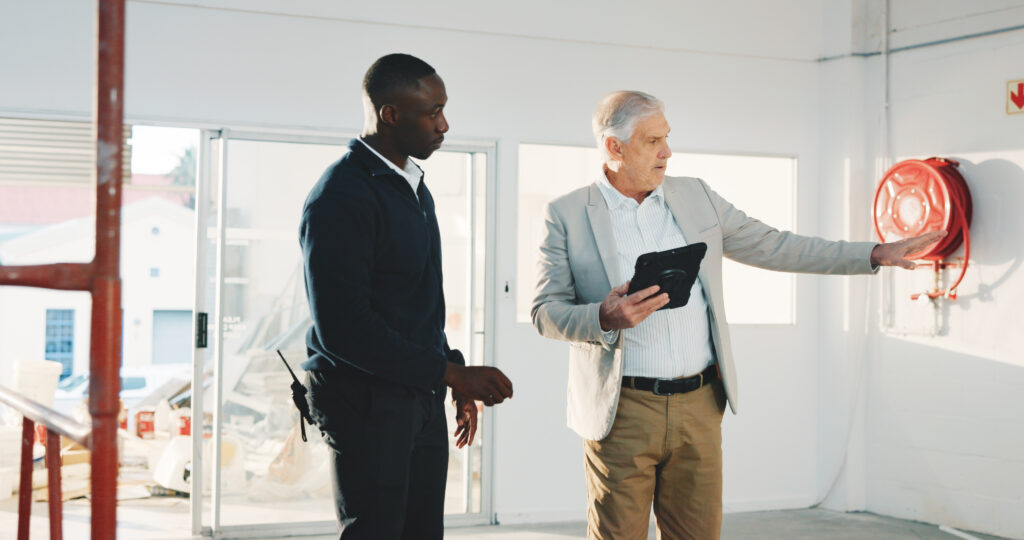 Senior manager and engineer discussing an industrial site