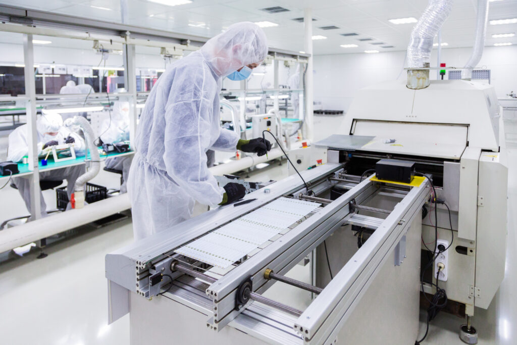 Workers in clean suits in a manufacturing facility
