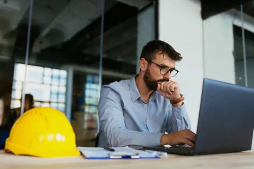 Engineer reviewing case documents at a workstation