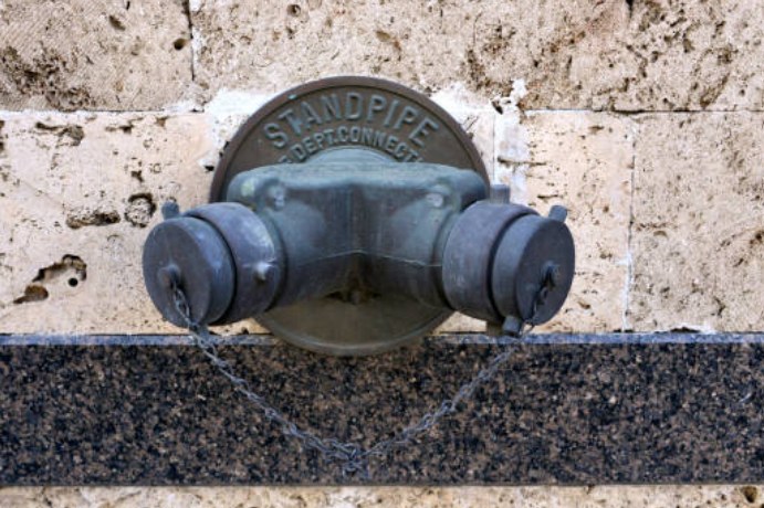 Standpipe fire department connection on a building wall